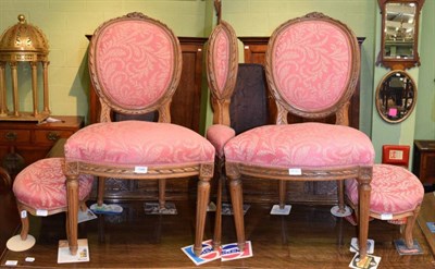 Lot 1386 - A pair of Louis XVI style walnut balloon back dining chairs and a pair of matching foot stools