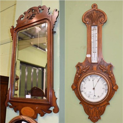 Lot 1392 - A Victorian carved oak aneroid barometer and a George III style mahogany breakfront mirror (2)