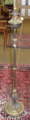 Lot 1246 - A 19th century brass adjustable standard lamp, the oil lamp fitting converted to electricity