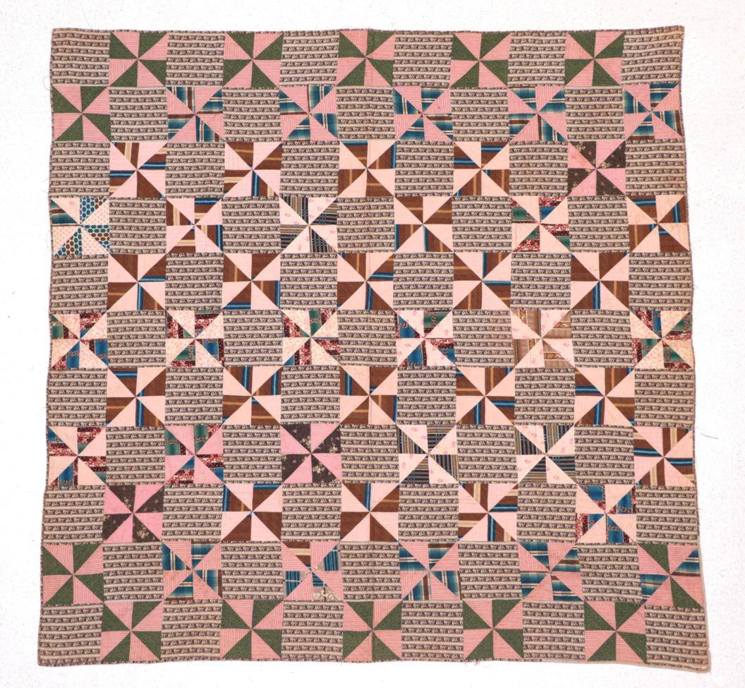 Lot 2018 - Circa 1870 American Pin Wheel Pattern Quilted Coverlet, incorporating squares of brown and...
