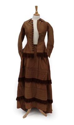 Lot 2114 - A Victorian Brown Silk Bustle Back Two Piece, comprising a fitted long sleeved jacket with...