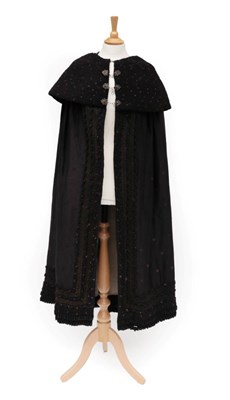 Lot 2119 - 19th Century Black Wool Cloak, woven with purple floral sprigs with a deep 'concertina' collar,...