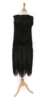 Lot 2126 - Circa 1920s Black Net Shift Dress, with black bugle bead decoration overall in scalloped...
