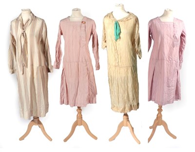 Lot 2132 - Four 1920s Day Dresses, comprising a dark cream collared dress, with button down details and...