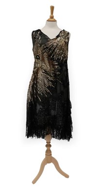 Lot 2135 - Circa 1920's Black Cotton Sleeveless Evening Dress, decorated with a large gold sequin 'flower...