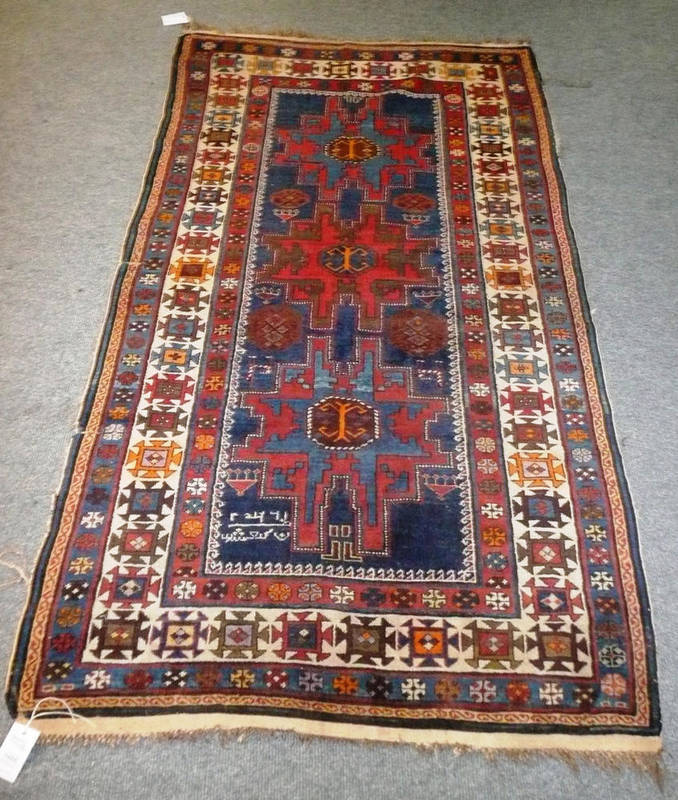 Lot 1405 - Lesghi Rug East Caucasus The indigo field with three typical stellar medallions flanked by...