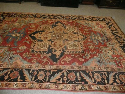 Lot 1410 - Heriz Carpet Persian Azerbaijan The soft madder field sparsely decorated with angular vines...