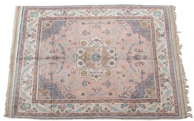 Lot 1415 - Ushak Carpet West Anatolia The faded salmon pink field sparsely decorated with angular leaves...