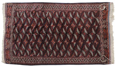 Lot 1425 - Yomut Carpet Emirate of Bukhara The aubergine field of Dynak guls enclosed by borders of hooked...