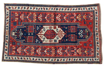 Lot 1428 - Fachralo Kazak Prayer Rug Central Caucasus The madder field of tribal and hooked motifs around...