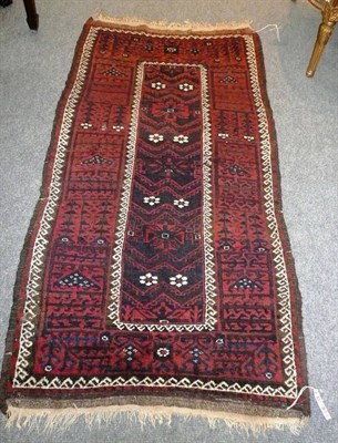 Lot 1443 - Balouch Rug Persian Afghan Frontier The narrow field with eight white flowerheads enclosed by a...