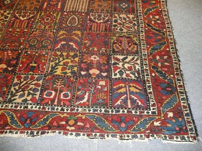 Lot 1444 - Bakhtiari Carpet West Persia The compartmentalised field of "garden" design enclosed by madder...