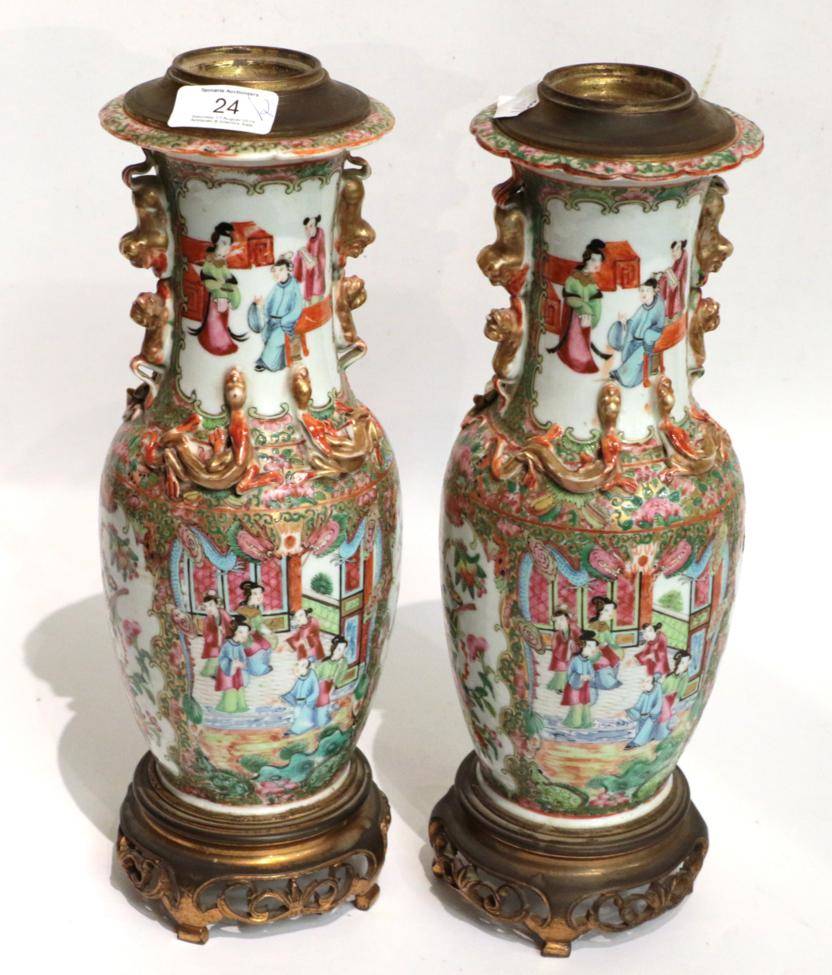 Lot 24 - A pair of 19th century Canton Famille rose vases, converted to table lamps with gilt metal mounts