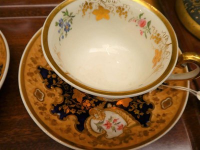 Lot 47 - A pair of Ridgeways tea cups and saucers, floral decorated and gilt highlighted on a cobalt...