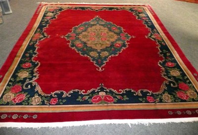 Lot 1451 - Kashan Carpet Central Persia The plain blood red field centred by a pale indigo rococo medallion of