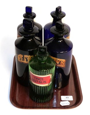 Lot 49 - Four 19th century blue glass apothecary bottles, together with a later green glass example (5)