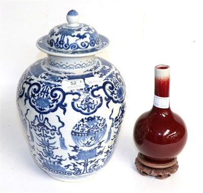 Lot 52 - A Chinese sang de boeuf bottle vase, together with a Chinese blue and white porcelain baluster vase