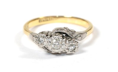 Lot 60 - A diamond three stone twist ring, stamped '18CT and PLAT', finger size R
