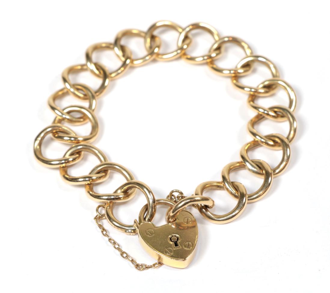 Lot 66 - A curb link bracelet with applied plaque stamped '15' and padlock clasp stamped '15CT' and...