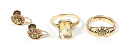 Lot 79 - A 9 carat gold peridot ring, finger size M; a pair of matching earrings, stamped '9CT';...
