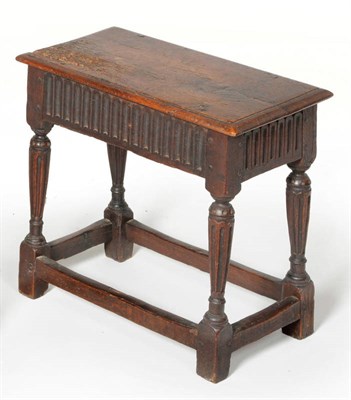 Lot 1455 - An Oak Joint Stool, the fluted frieze above turned tapering fluted legs united by a peripheral...