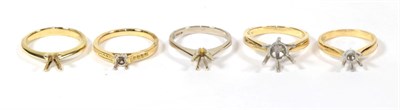Lot 89 - An 18 carat white gold vacant ring mount; and four 18 carat gold vacant ring mounts, varying...