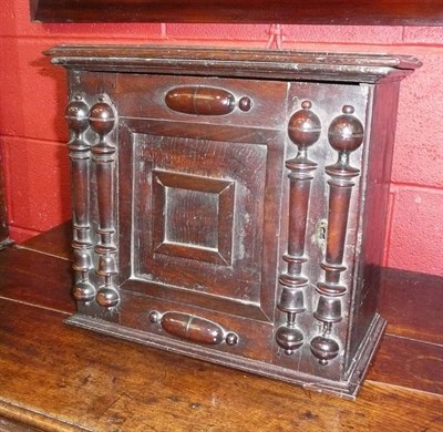 Lot 1456 - A Late 17th Century Oak Spice Cupboard, the moulded top above a fielded panel door with applied...