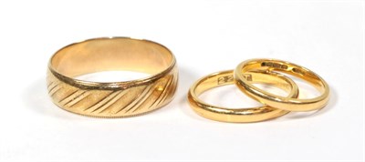 Lot 107 - A 9 carat gold band ring, finger size Z; a 22 carat gold band ring, finger size J; and a ring...