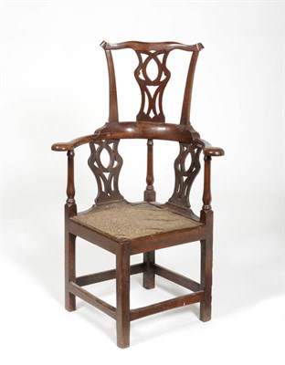 Lot 1457 - A George III Oak and Elm Corner Chair with Headrest, the pierced splat above outswept arms, the...