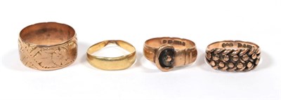 Lot 114 - A 9 carat gold buckle ring, finger size M; a 9 carat gold patterned band ring, finger size Q; a...