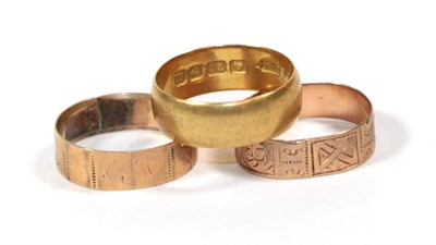 Lot 122 - A 22 carat gold band ring, finger size K1/2; and two 9 carat gold patterned band rings, finger...
