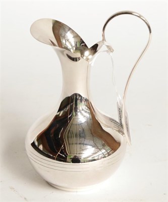 Lot 132 - An Elizabeth II silver jug, by Victoria Silverware Ltd., Birmingham, 2003, baluster and with scroll