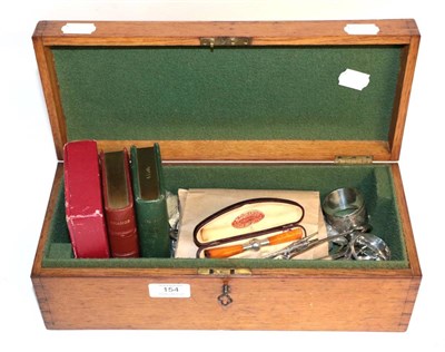 Lot 154 - An oak box with a quantity of keys; plated flatware; amber cigar holder; silver napkin ring etc
