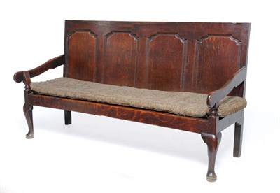 Lot 1465 - A George III Oak Settle, late 18th century, the back support with four fielded panels above...