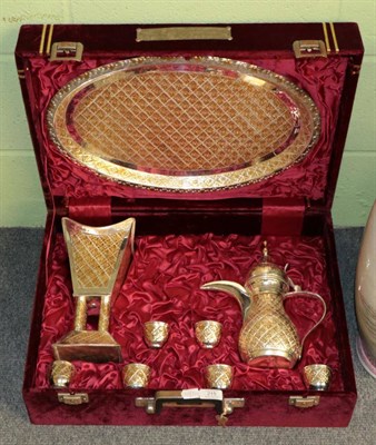 Lot 215 - A Middle-Eastern parcel-gilt coffee-service, comprising: a Dallah-style coffee-pot; an oval...