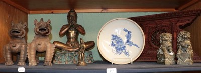 Lot 217 - A group of Oriental statues and models including a pair of Chinese soapstone temple lions, a...