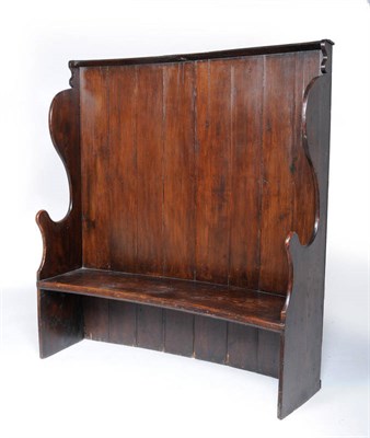 Lot 1468 - A George III Stained Pine and Elm Winged Settle, early 19th century, the boarded back above...