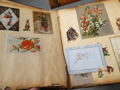 Lot 259 - A Victorian scrap album containing chromolithographic scraps, cut-paper greetings cards, etc,...