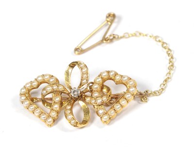 Lot 279 - A seed pearl set double heart brooch, stamped '18', length 3cm