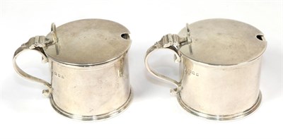 Lot 280 - A pair of George V silver mustard-pots, by Thomas, London, 1934, drum-shaped and with blue...