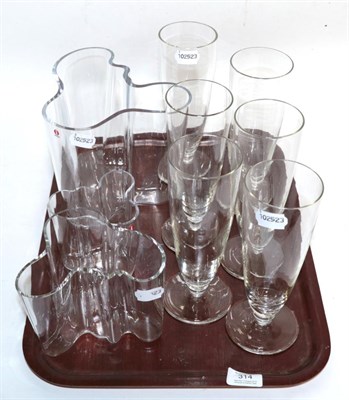 Lot 314 - A graduated set of three Alvar Aalto ''Savoy'' glass vases; and a set of six tall pedestal glasses