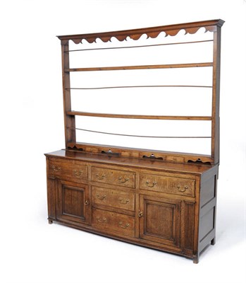 Lot 1479 - A George III Oak Enclosed High Dresser and Rack, late 18th century, the moulded cornice above a...