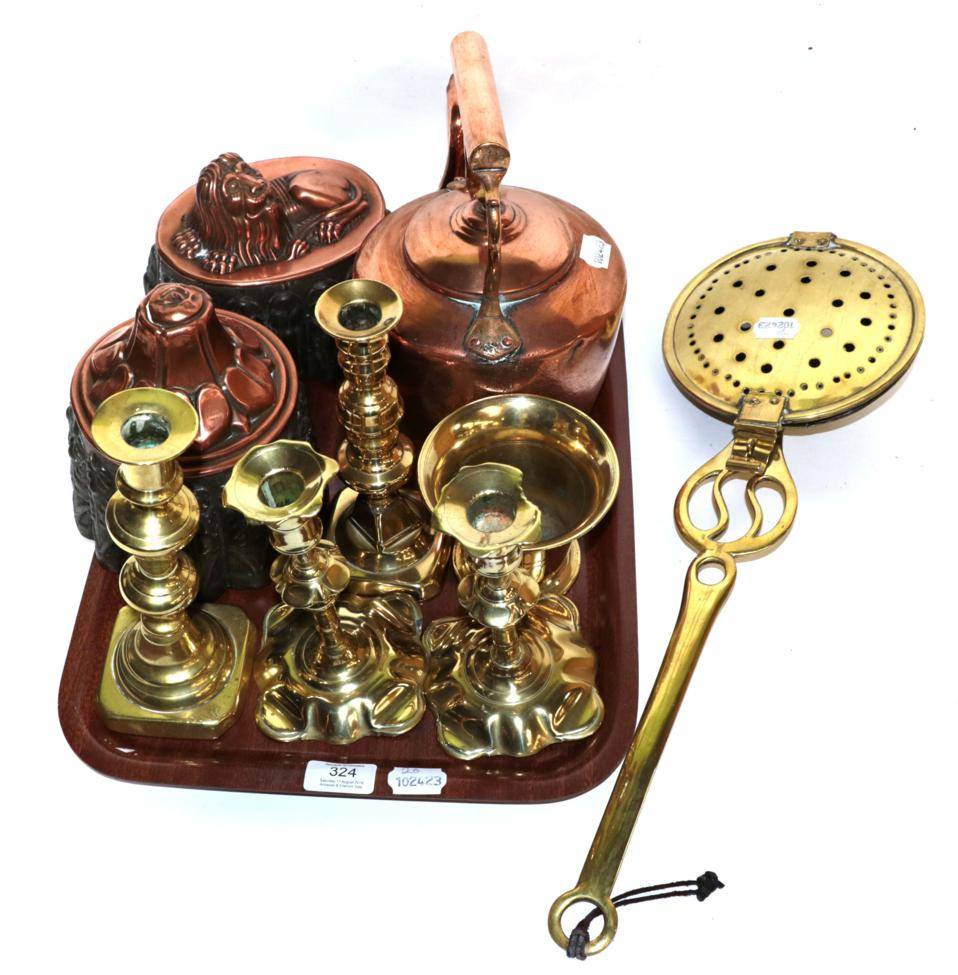 Lot 324 - Two 19th century copper jelly moulds, a Victorian copper kettle, two pairs of brass candlesticks, a