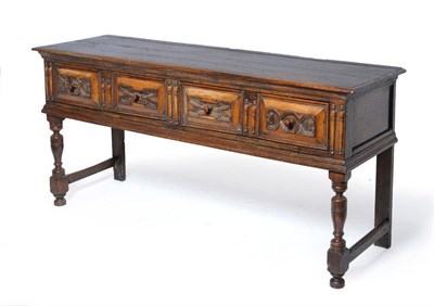 Lot 1481 - A Charles II Oak Low Dresser, late 17th century, the boarded top above two frieze drawers with four