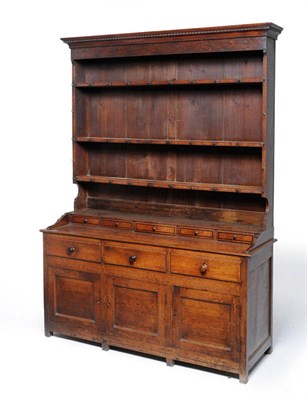 Lot 1482 - A George III Oak Enclosed Dresser, late 18th century, the rack with a cavetto cornice above a plain