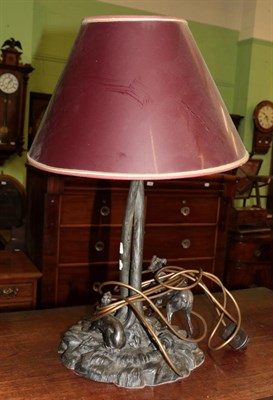 Lot 379 - A modern bronzed table lamp in the form of two greyhounds playing around a tree, on a...