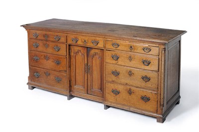 Lot 1486 - A Mid 18th Century Oak Low Dresser, the boarded top above a central frieze drawer with two...