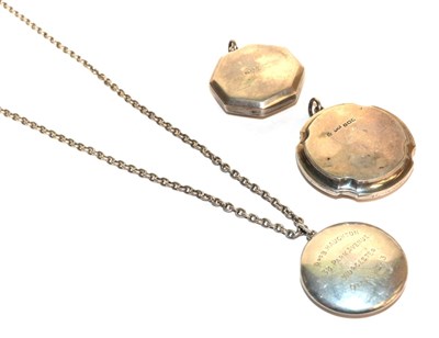 Lot 397 - Three small silver pendant powder compacts (one on a chain) (3)