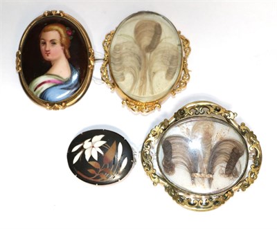 Lot 398 - Two oval mourning brooches; a sliver mounted hardstone brooch, and an oval porcelain portrait...