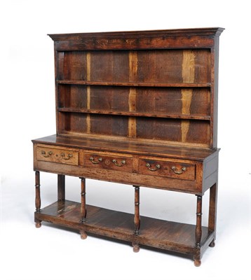 Lot 1487 - A George II Oak Open Tall Dresser and Rack, mid 18th century, the moulded cornice above a plain...